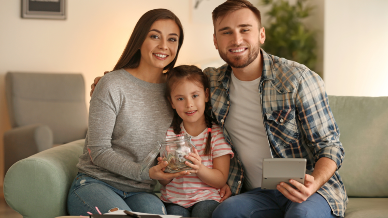 Smiling young family at home, symbolising protection and peace of mind with help from a life insurance broker in Melbourne.