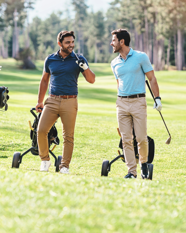 Two people enjoying a game of golf on a sunny day, representing a relaxed and well-planned retirement lifestyle.